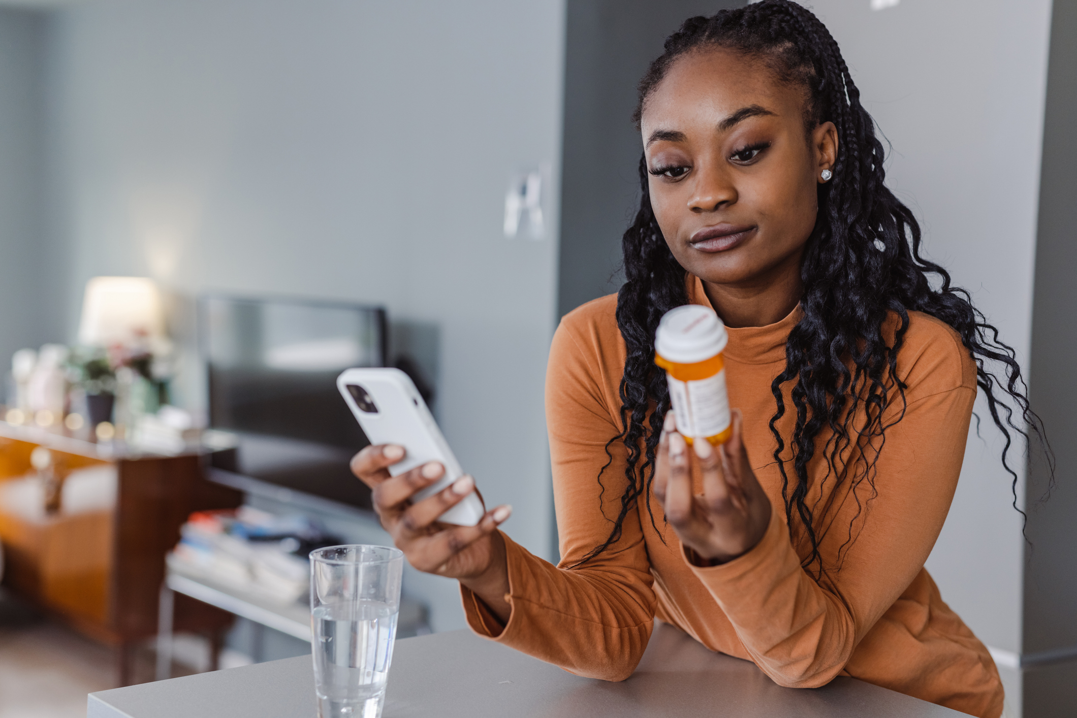 Woman reading medicine bottle label