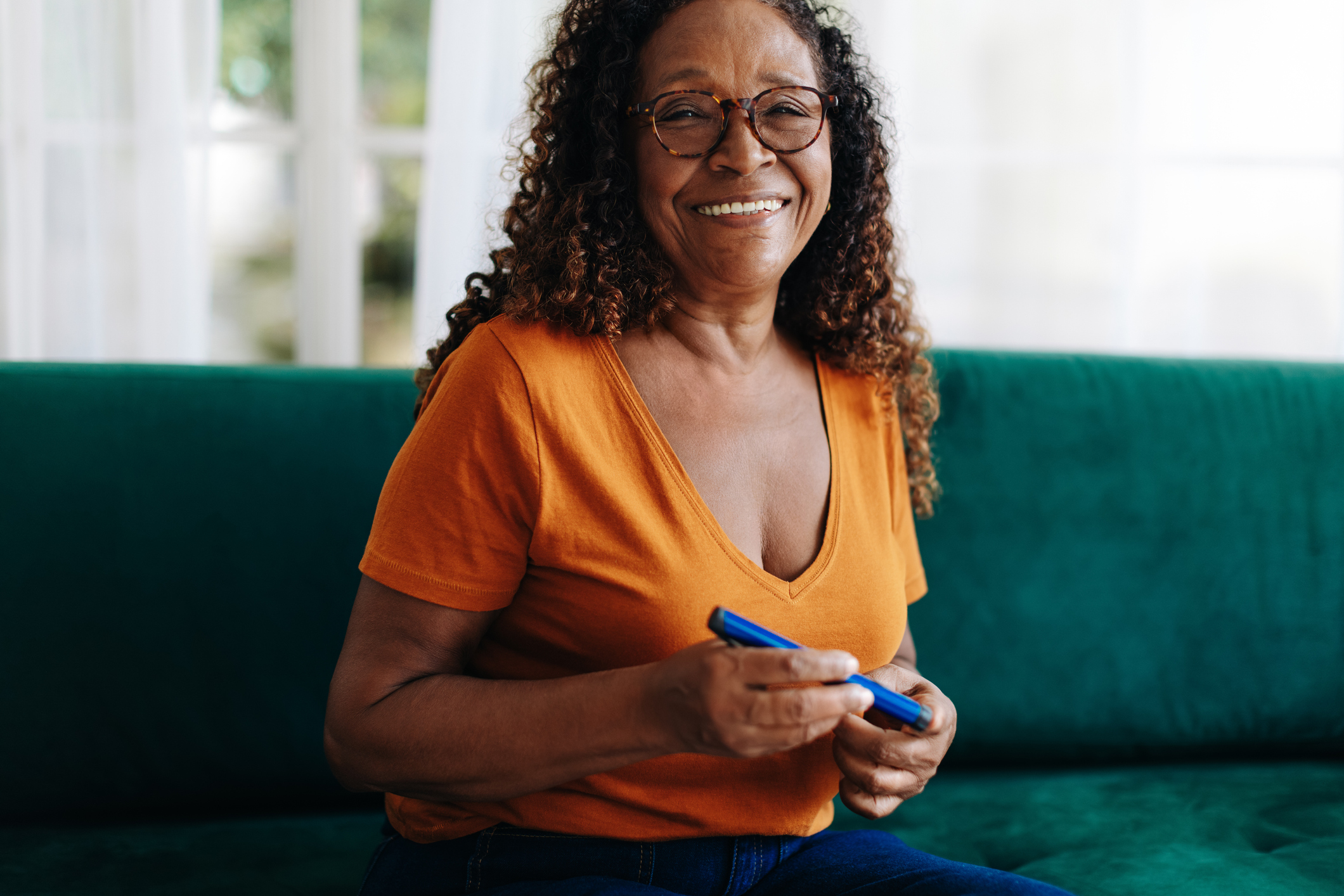 Older woman using lancet on finger to check her blood sugar level