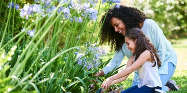 mother-and-daughter-planting-flowers-in-garden-picture-id1310289685