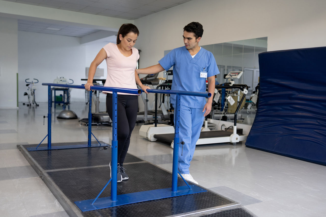 Physical therapist helping woman stretch her foot