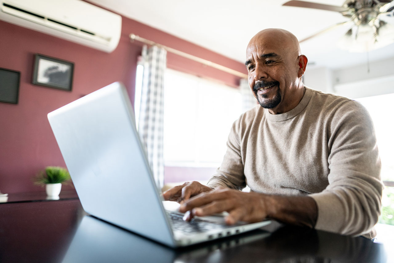 Man using a laptop to access the virtual-first behavioral health solution